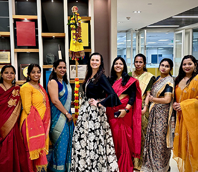 Angela standing with other Indian colleges on festival celebration
