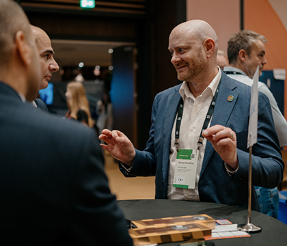 Brad talking to two men at the AUTOMA event.