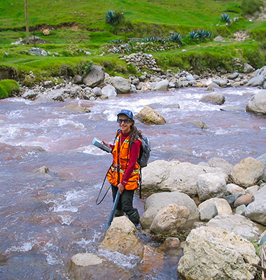 Carola standing in the middle of creek in running water.