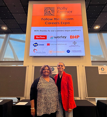 Cheroke standing next to a woman at the Polly Farmer Careers Expo.