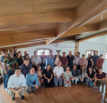 Consuelo with group of people posing together indoors.