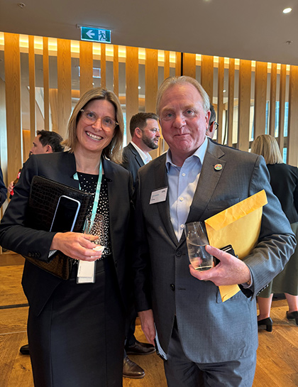 Erica standing next to Chris Ashton, CEO of Worley, at an event.