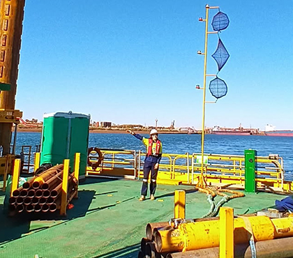 Kaitlin wearing PPE standing on an offshore platform.