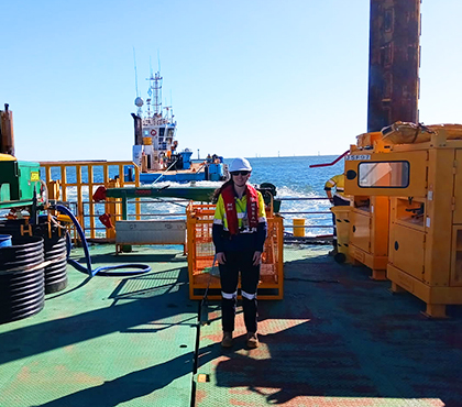 Kaitlin wearing PPE standing on an offshore platform.