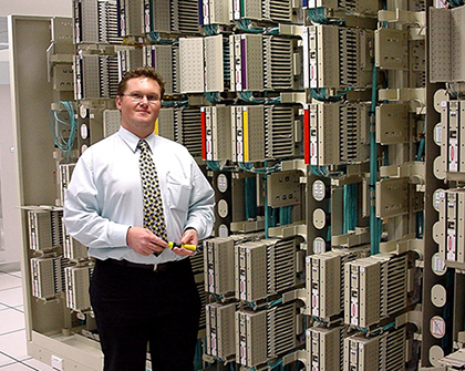 Nathan standing in front of rows of data servers.