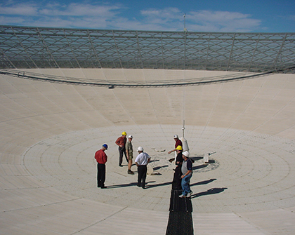 Nathan with his team standing inside Murriyang, the 64 metre telescope in Parkes NSW.