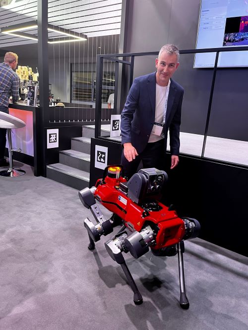 Paul standing next to a robotic machine.