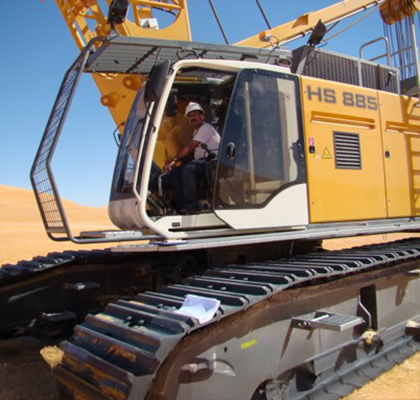 Raj operating a hydraulic crawler crane.