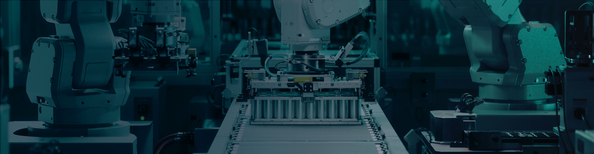 Robotic arms building electric car battery packs.