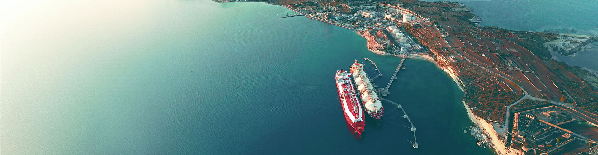 Aerial view of LNG tankers near port.