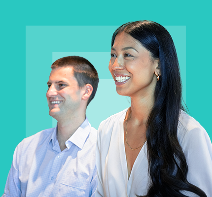 Two Worley people sitting together listening to a speaker.