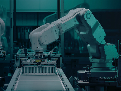 Robotic arms building electric car battery packs.