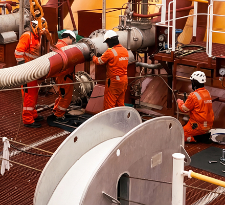 People wearing PPE working on an LNG tanker.
