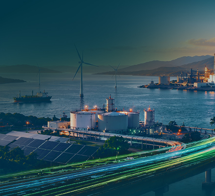 Integrated energy and industrial complex beside a coastline, featuring wind turbines, storage tanks, port facilities and transport links.