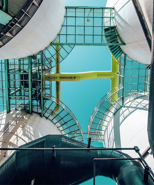 Looking up onto four fuel storage tanks.