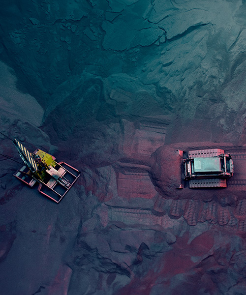 Aerial view of machinery at an iron ore transfer and storage center.