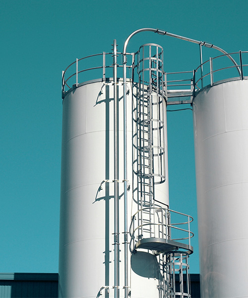 Two white storage tanks.