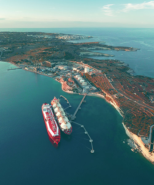 Aerial view of LNG tankers near port.