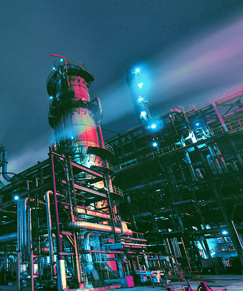 Refinery plant at night with bright lights.