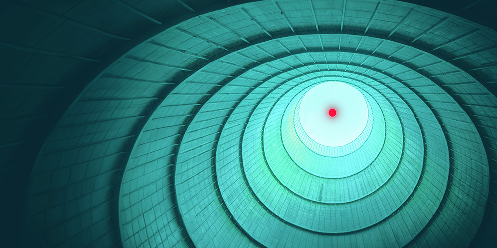 Inside a nuclear cooling tower looking out into the sky.