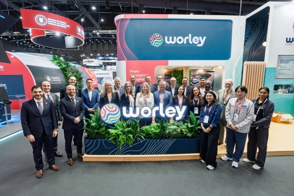 Craig and a large group of colleagues in the Worley standing at Gastech conference.