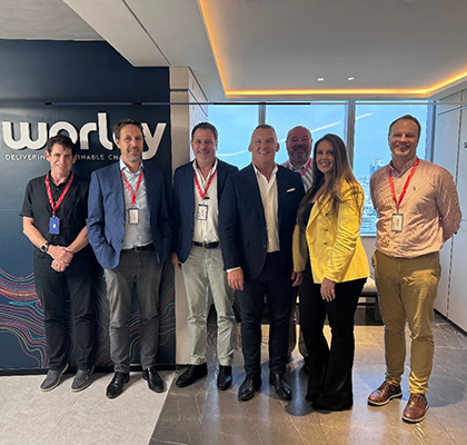 Gavin standing with a group of colleagues inside Worley office.
