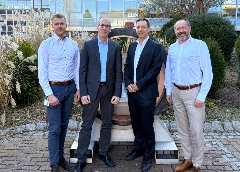 Four people from Aquaductus and Worley standing together outside a building.