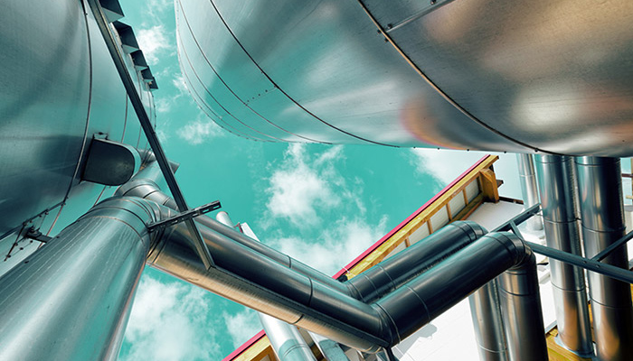 Looking skywards through steel pipes and containers.