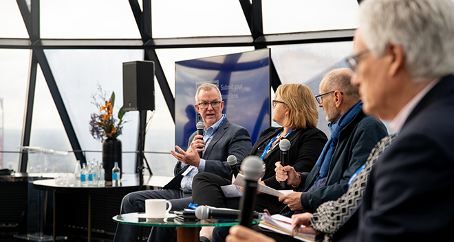 Dr Chris Greig talking in the panel at the UK Breakfast Briefing.