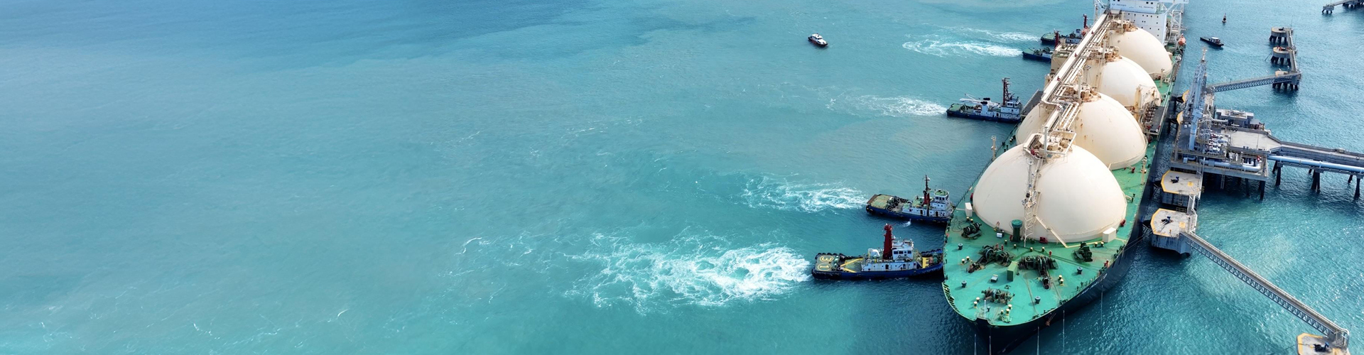 Aerial view of LNG tanker docked in the ocean.