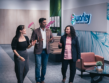 Three people in a Worley India office walking together talking.