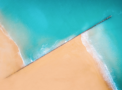 Aerial view of ocean and land.